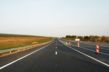 Empty highway with asphalt road and cloudy sky