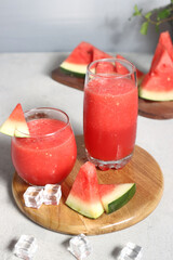 Jus semangka. Watermelon smoothie fresh juice and slices of watermelon. Healthy drinks in glasses on a white background.