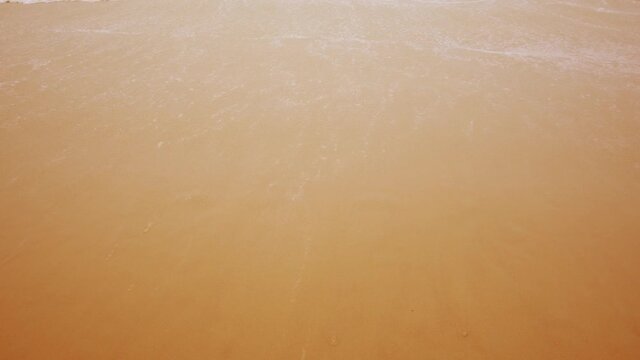 2020-2021 Change New year on the beach. 2020 handwritten sand texture  The water wave erased and changed to 2021. 