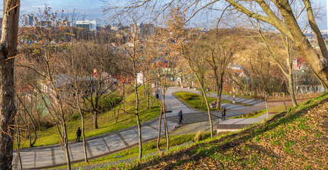 People walk along the Landscape Alley and admire the view of the old Podil, Kyiv, Ukraine