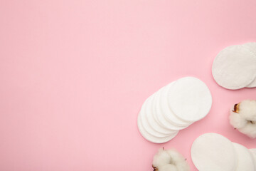 Hygienic disposable product cosmetic pads and cotton flower on pink background