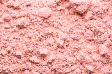 Pink texture of loose blush close up. Loose powdery make-up product. Broken compact powder close-up. Beauty cosmetic mineral organic product.