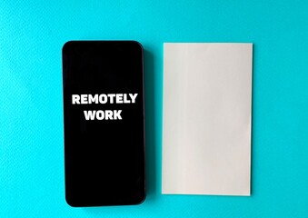 Remotely work on a black phone, next to a sheet of paper on a blue background.There is a place to place the text .The concept of remote work during a pandemic.