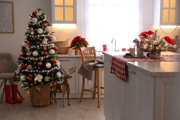 Beautiful kitchen interior with Christmas tree and festive decor