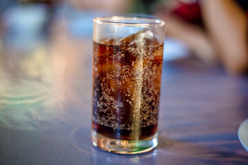 Blurred abstract background of hands eating on a table like seafood (Baked shrimp vermicelli, deep fried sea bass with fish sauce, yum squid) eaten alongside soft drinks, while on vacation with family