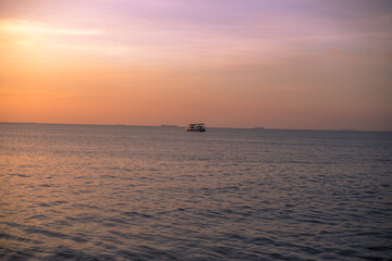 Close-up background Of the sun on the lake and the fishing boats docked, the wind blows through a cool