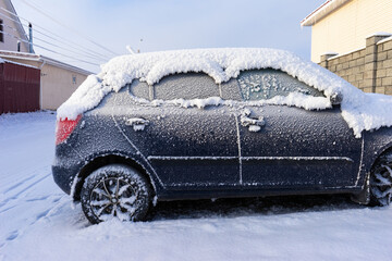 frozen car. the side of the car, doors and handles covered with snow and frost.