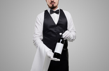 Anonymous waiter offering wine to camera