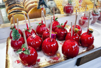 Red Apples with caramel in Christmas market in Paris.