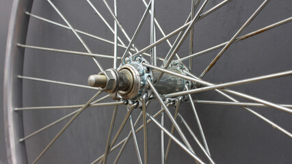 Gray bicycle disc made of steel close up. Part, fragment of a bicycle wheel on a gray background....