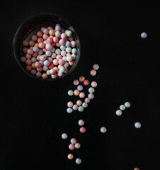 blush in balls on a black background