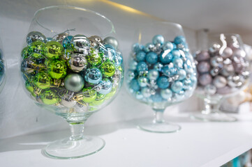 Shop counter with Christmas balls in glasses