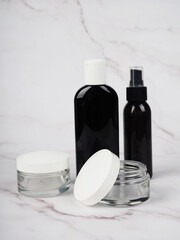 Fototapeta na wymiar black antiseptic bottles on marble background. Concept of hygiene and protection against coronavirus