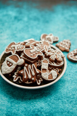 Delicious fresh Christmas decorated gingerbread cookies placed in wooden crate