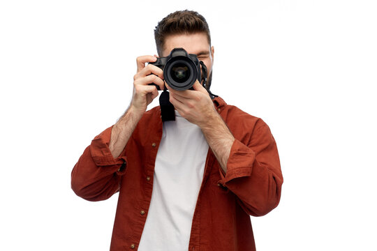 photography, profession and people and concept - happy smiling man or photographer with digital camera over white background