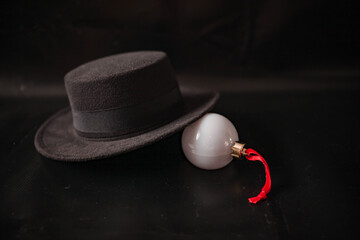 hat, glasses and Christmas ball on a black background