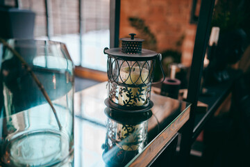 candle in a glass on the table