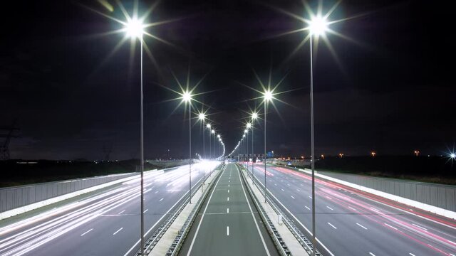 Time-lapse of highway traffic during the evening. Wide highway road with five lanes in each direction and two reversible lanes in the middle, connecting Amsterdam and the east of the Netherlands