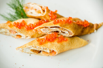 pancakes rolls with salmon and red caviar