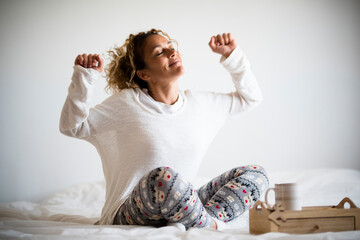 Happiness and good life concept with happy adult young woman wake up and enjoy the morning light -...