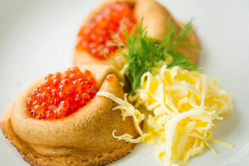fresh pancakes with red caviar and oil