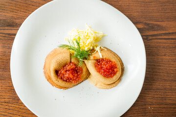 fresh pancakes with red caviar and oil
