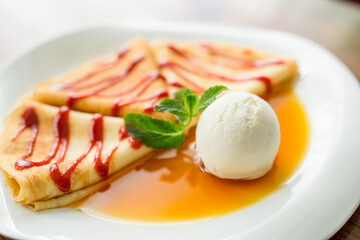 pancakes with sauce, honey and ice cream