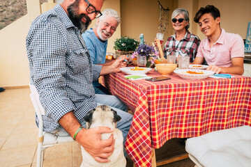 Happy caucasian cheerful family enjoy together lunch outdoor at home having fun - people celebrate...