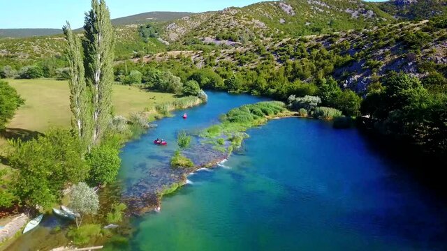 Flight over the Zrmanja river by rafting boats near Zadar in Croatia 4K