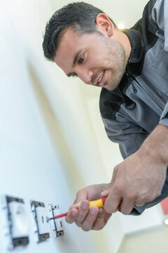 Electrician working on electric socket
