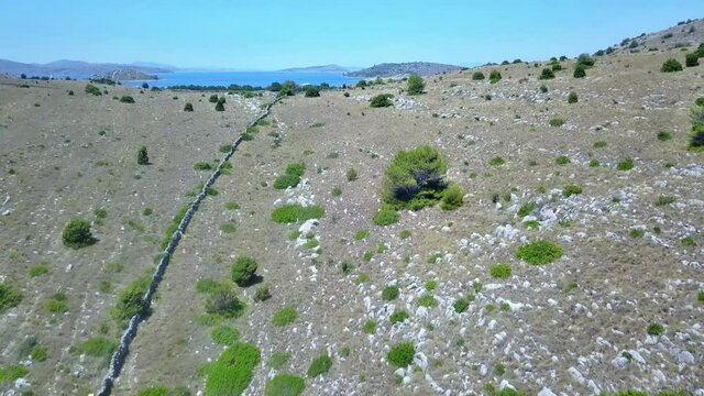 Flight over a hill with the Kornati island group in the background Croatia 4K