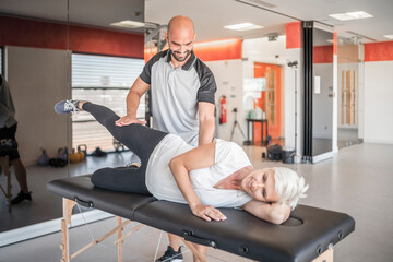 Pregnant woman exercising with personal trainer