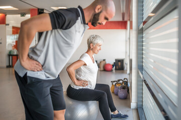 Pregnant woman exercising with personal trainer