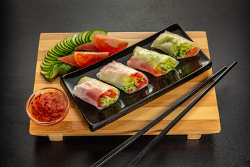 vietnamese spring rolls with Salmon and sauce on gray background