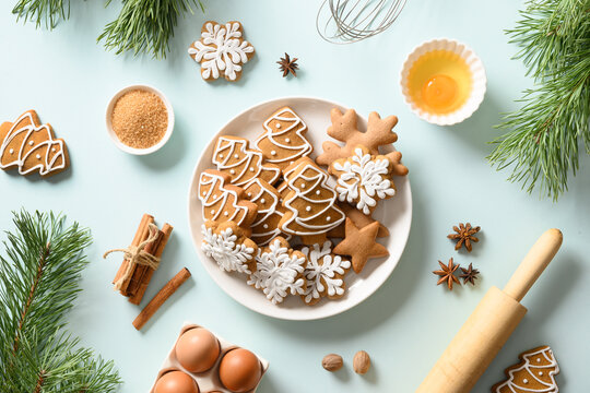 Christmas gingerbread cookies on blue. Merry Christmas and Happy New Year baking background. Flat lay style.