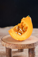 Labu kabocha. Ripe pumpkin, sliced pumpkin, pumpkin on the old board background