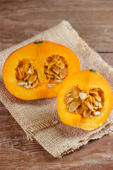 Labu kabocha. Ripe pumpkin, sliced pumpkin, pumpkin on the old board background