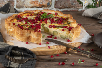 Homemade quiche with vegetables, brussels spouts, goat cheese and pomegranate. Vegetarian food....