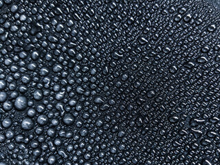 Water drops on black glass background