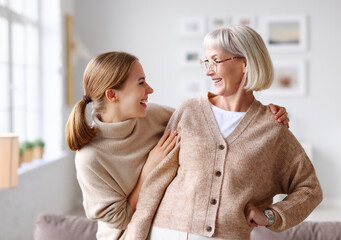 Delighted women looking at each other at home.
