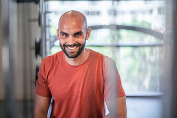 Sweaty man resting between workouts at the gym