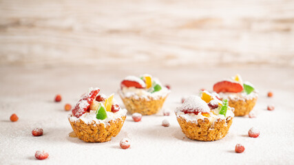Snow-covered sweet cakes with healthy and nutritious filling in oatmeal baskets. Winter sweet and healthy breakfast