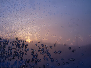 Background image. Frost patterns on glass. Dawn. Blue tones.