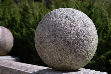 A large round stone placed on the wall
