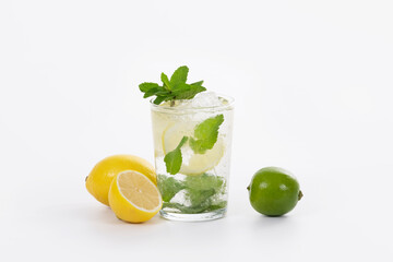 view of a tempting looking mojito cocktail surrounded by lemons and a lime
