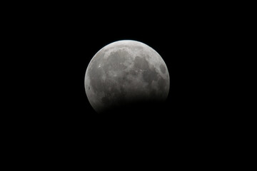 Large moon close-up at night on a black background, isolated