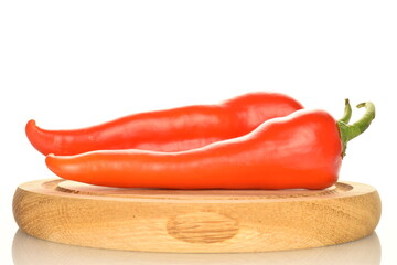 Several red sweet, natural peppers, close-up, isolated on white.