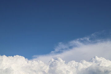 White thick clouds and blue sky background. Sunny day