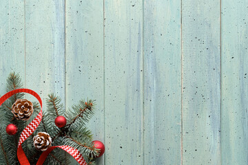 Zero Waste low impact Christmas background with copy-space. Xmas flat lay, top view on mint blue wood Panoramic banner, text space Fir twigs, cones, star cookies and red Xmas tree baubles, toys.