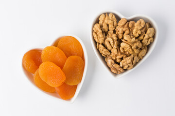 Dried apricots in heart shape bowls in studio 